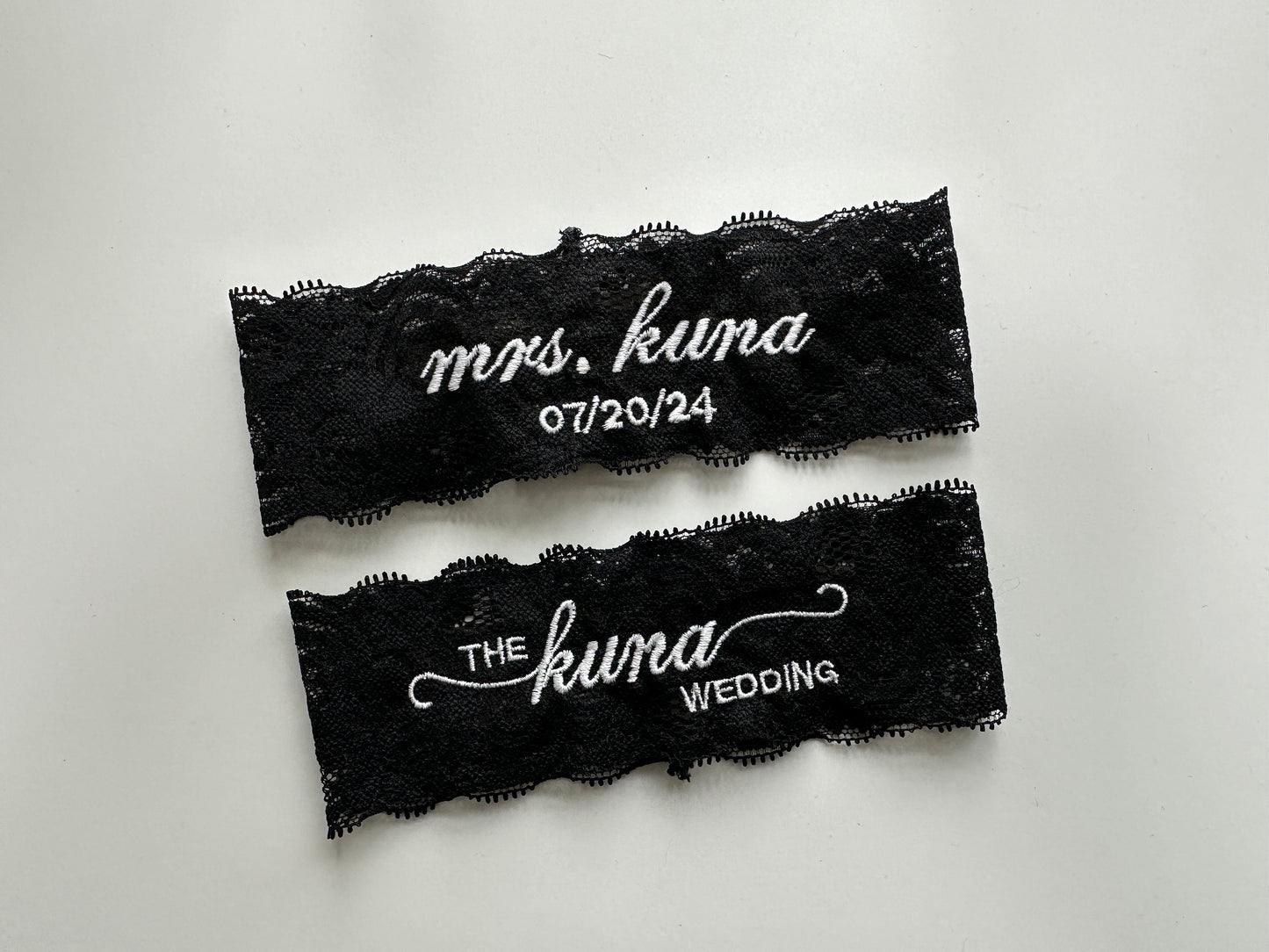Black lace garters with white text on a light gray background