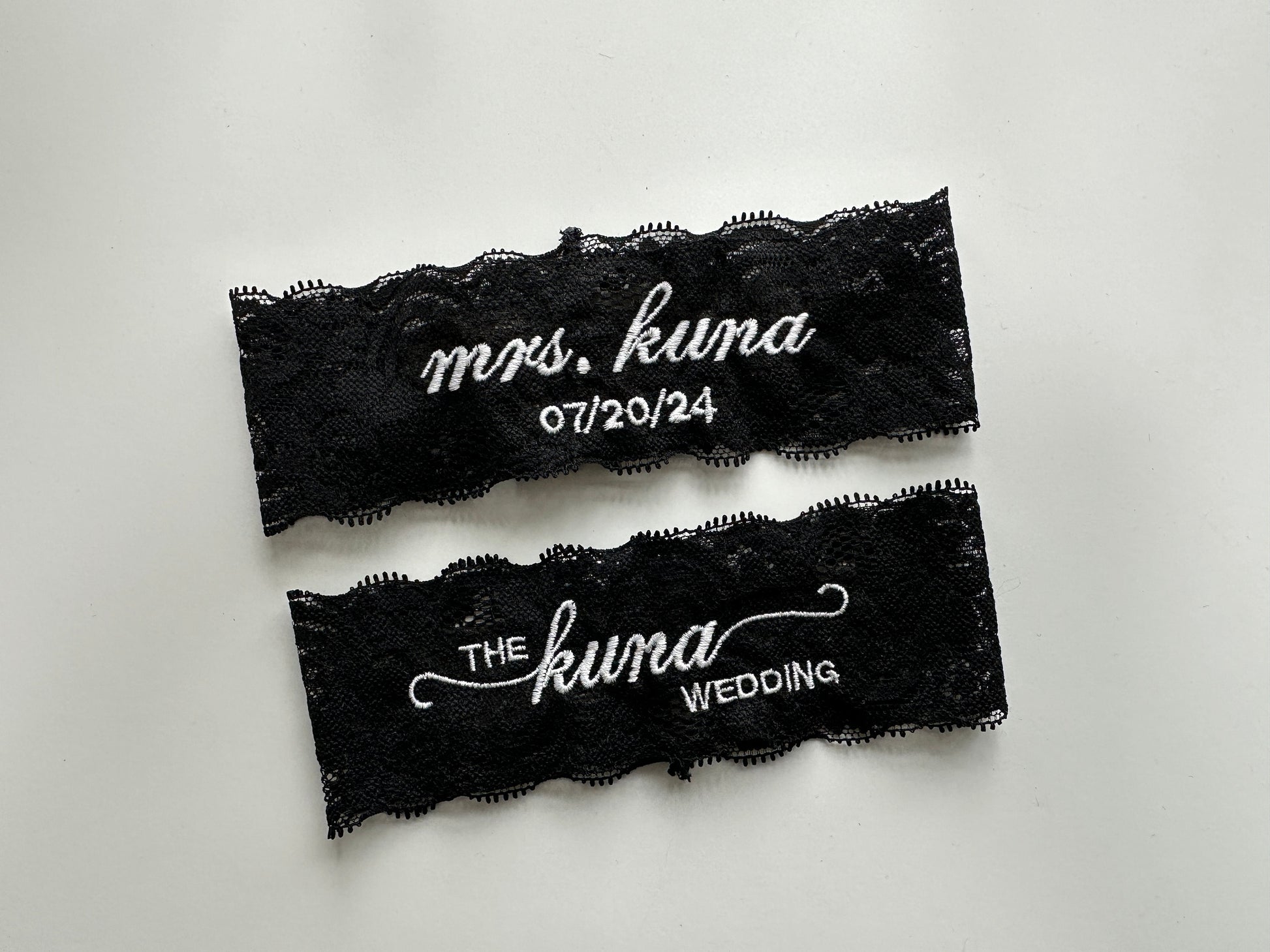 Black lace garters with white text on a light gray background